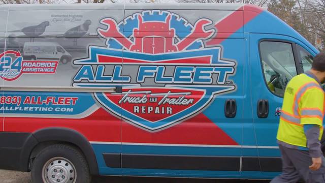 All Fleet Inc technician walking past a branded All Fleet Inc service van
