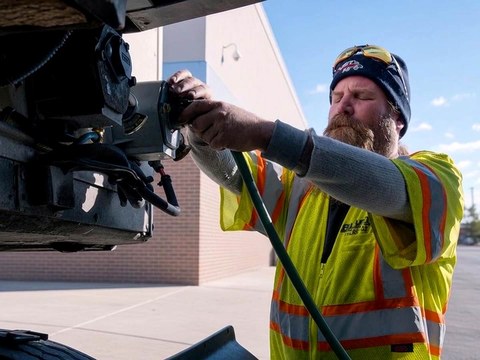All Fleet Inc technician connecting a trailer electrical cable